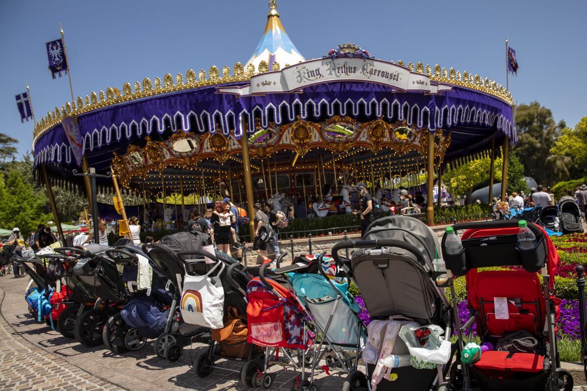Strollers ring the King Arthur Carrousel inside the Disneyland Resort.