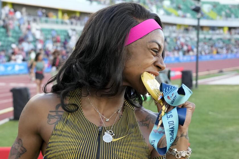 Sha'Carri Richardson celebrates her win in the wins women's 100-meter run final.