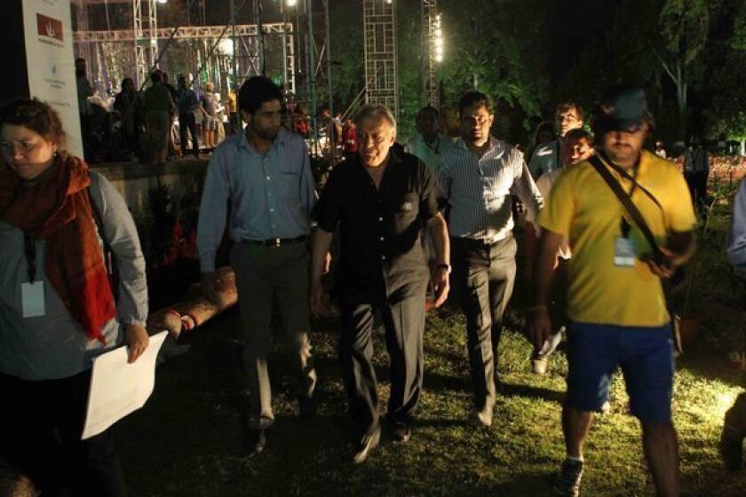 Zubin Mehta walks around the historic Shalimar Mughal Garden in Srinagar, the site of his planned peace concert in the Indian-controlled portion of Kashmir