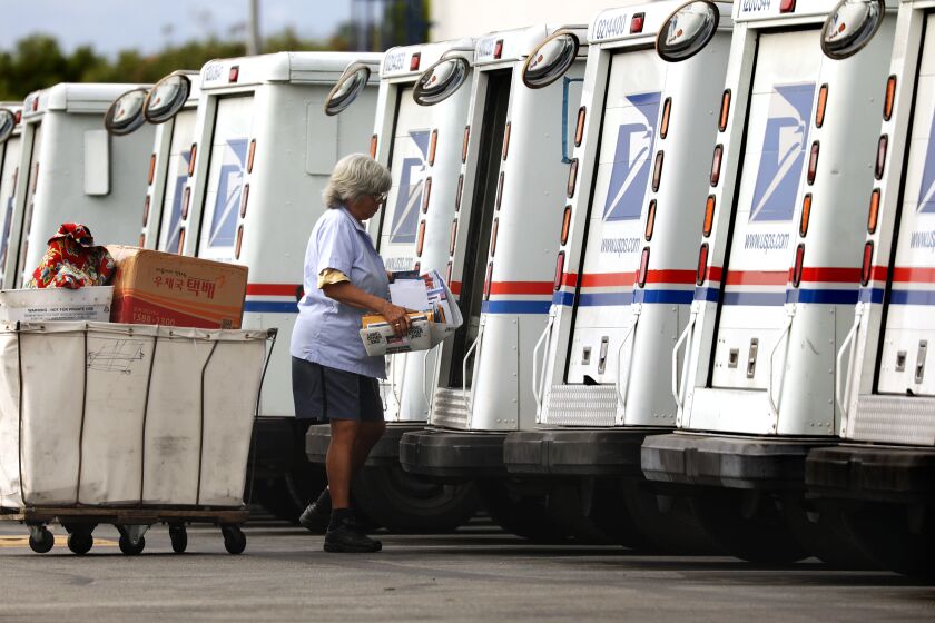 TORRANCE-AUGUST 26, 2020: A mail carrier loads a truck for delivery at a United States Post Office in Torrance on Wednesday, August 26, 2020. (Christina House / Los Angeles Times)