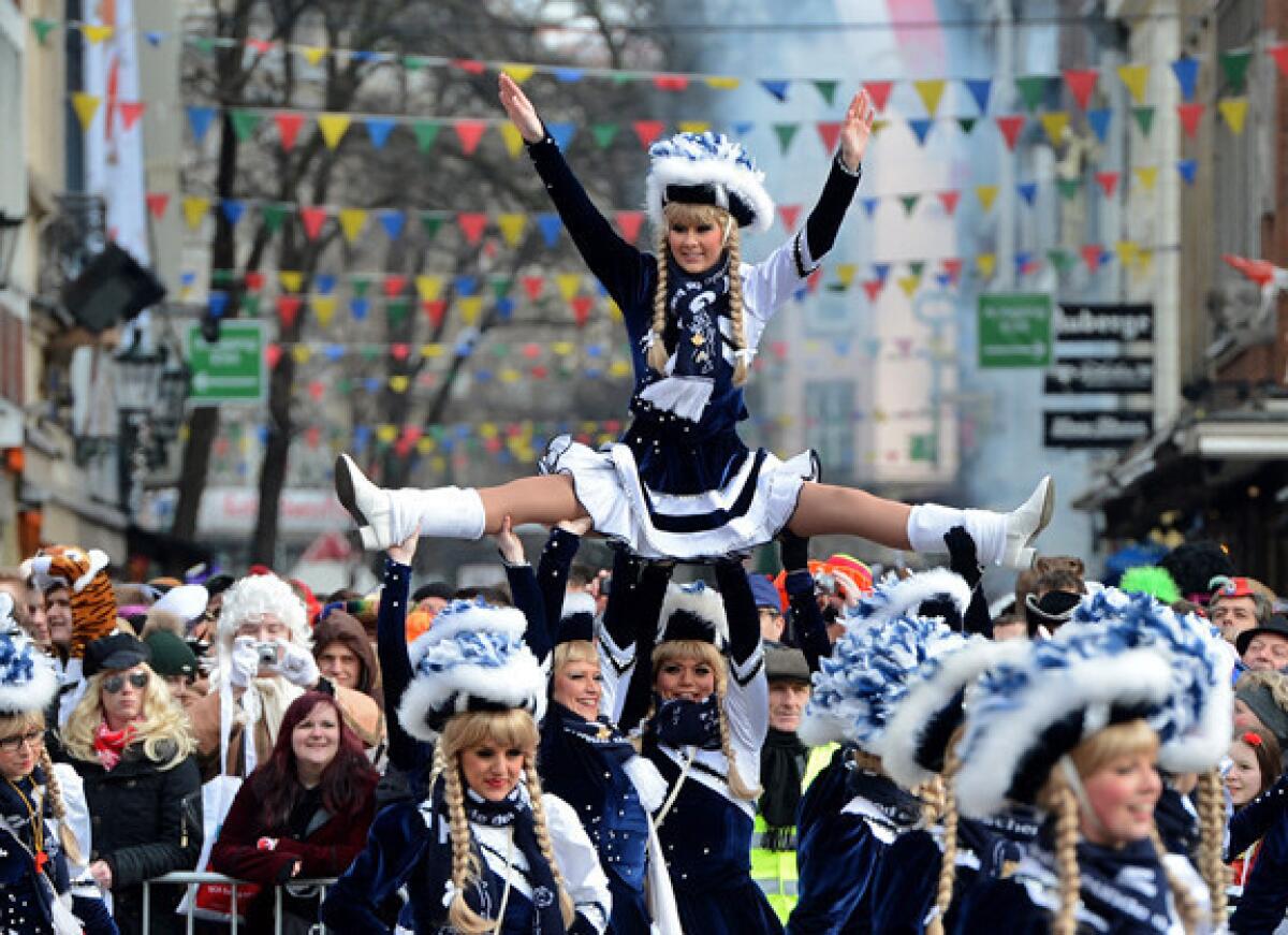 People celebrate in the streets of Dusseldorf, Germany, during the Rose Monday parade.