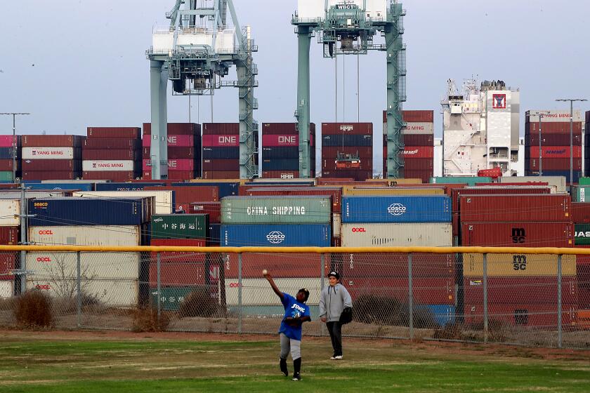 LOS ANGELES, CALIF. - NOV. 18, 2021. Kids play on a Little League baseball field that ocverlooks the Port of Los Angeles in San Pedro. (Luis Sinco / Los Angeles Times)