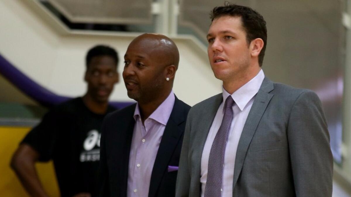 Lakers Coach Luke Walton, right, talks with Brian Shaw, who will be one of his main assistant coaches, before a news conference on June 20.
