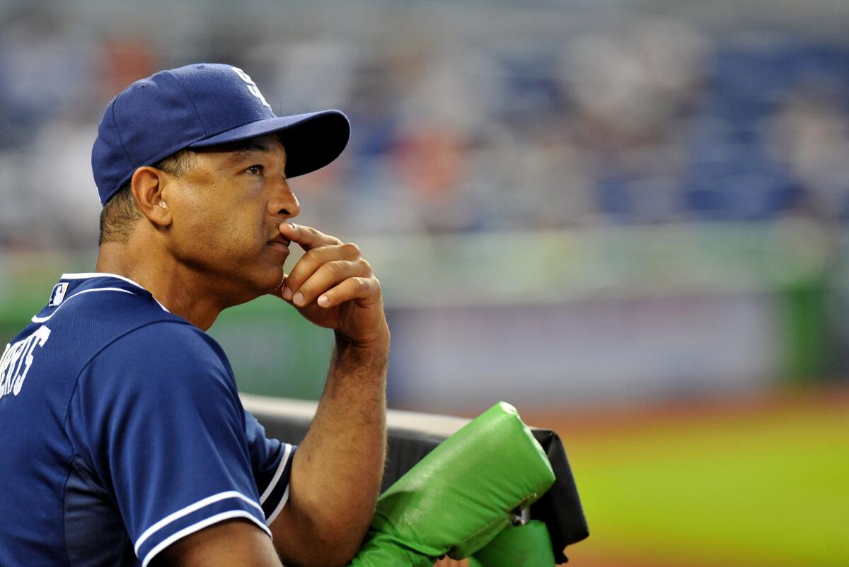 Dave Roberts looks on from the San Diego Padres' dugout during a game against the Marlins in Miami on June 30, 2013.