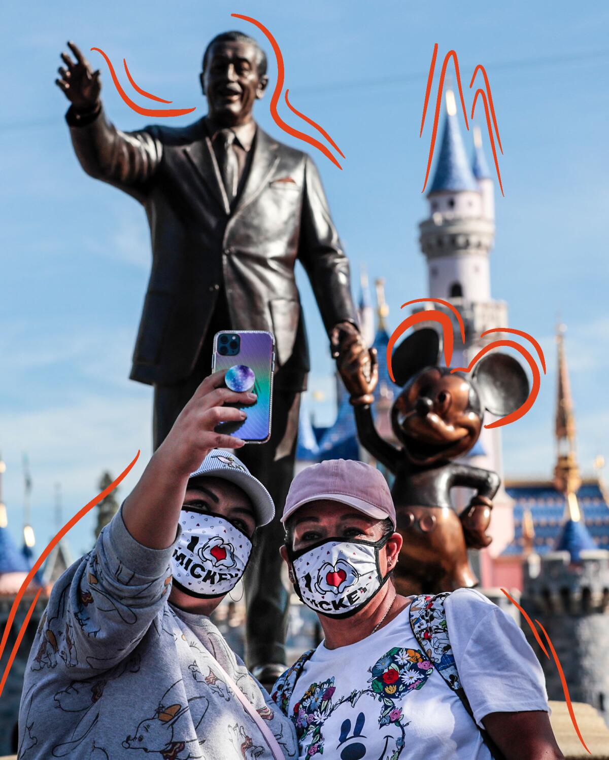 Park visitors take a selfie in front of the Walt Disney statue inside Disneyland.