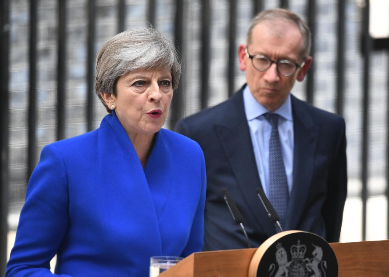 Britain's Prime Minister Theresa May, flanked by her husband Philip after meeting the Queen in Buckingham Palace in London, Britain, on June 9. 2017.