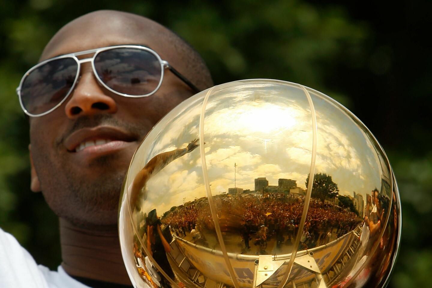 Kobe Bryant holds the championship trophy during the Lakers 2010 victory parade.