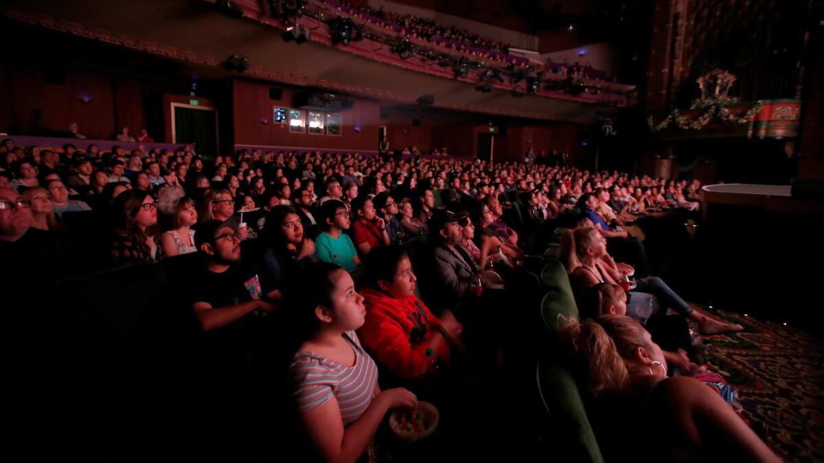 The audience at Hollywood's El Capitan Theatre watches "Beauty and the Beast" on Thursday night.