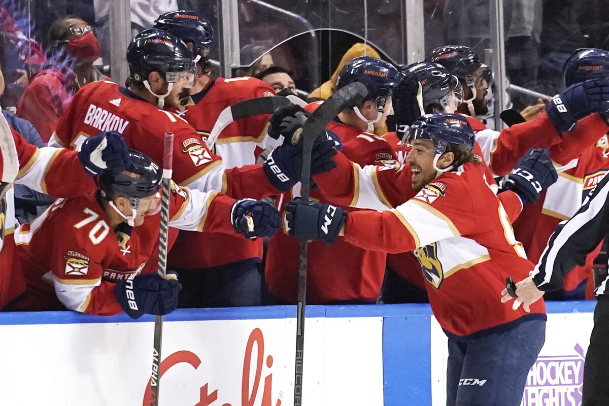Florida Panthers left wing Ryan Lomberg, right, celebrates after scoring a goal during the second period of an NHL hockey game against the Calgary Flames, Tuesday, Jan. 4, 2022, in Sunrise, Fla. (AP Photo/Lynne Sladky)