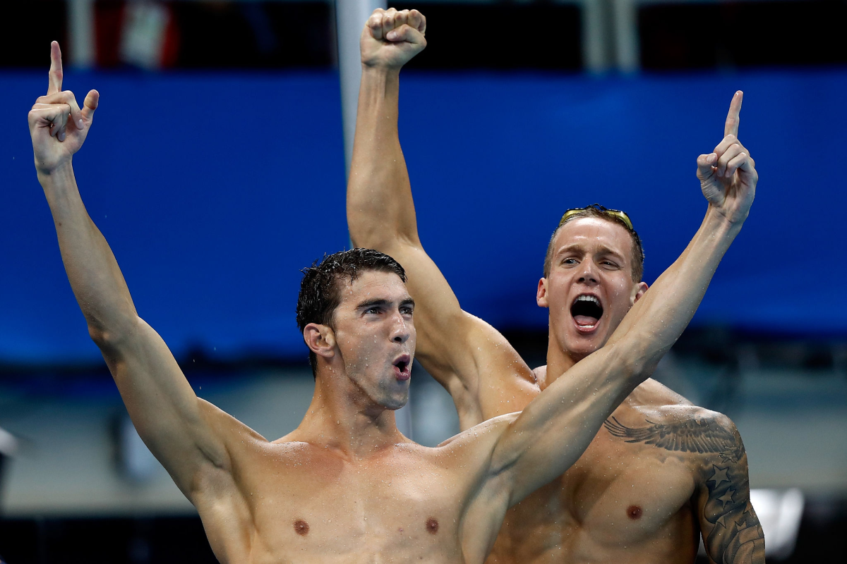 Michael Phelps, front, and Caeleb Dressel celebrate after winning gold for the U.S. in the men's 4X100 freestyle relay.