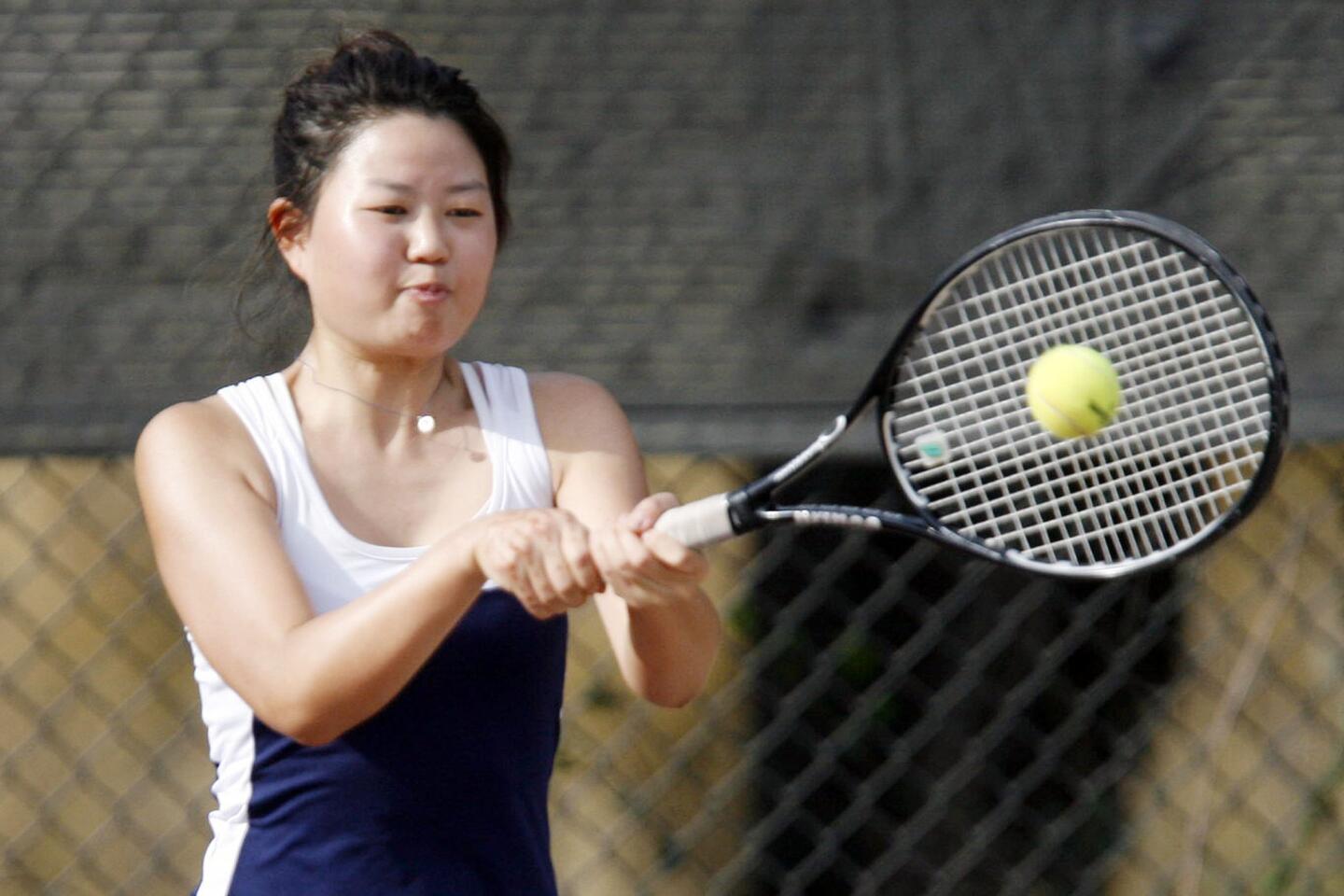 Flintridge Prep's Young-In Kim hits the ball during a match against Pasadea Poly at Scholl Canyon Tennis Center in Glendale on Friday, September 21, 2012.
