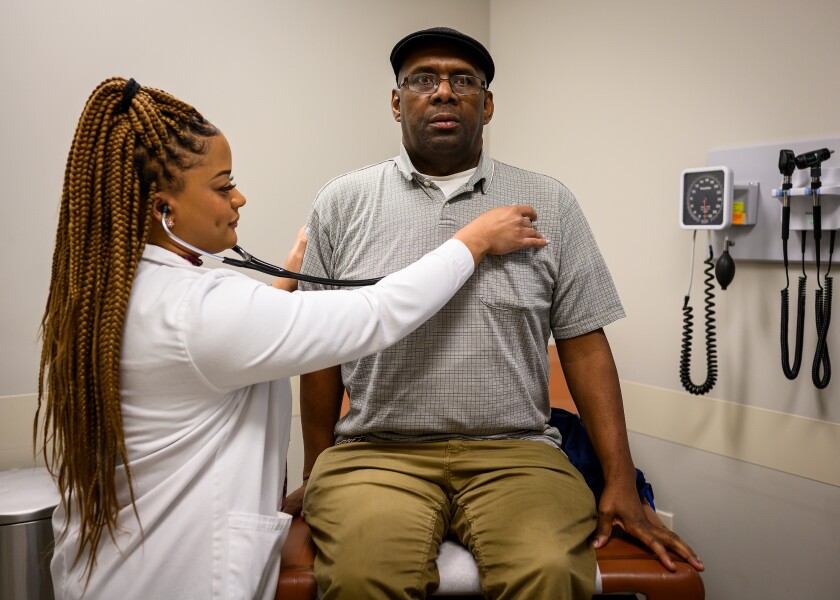 Dr. Adrienne Hatchett gives a checkup to Samuel Camon at the East Arkansas Family Health Center in West Memphis, Ark.
