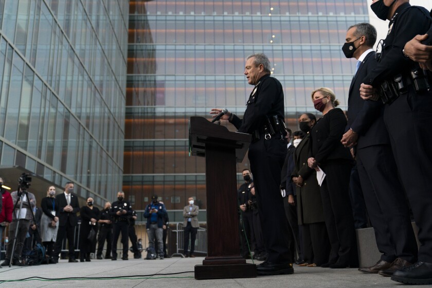 Los Angeles Police Chief Michel Moore, center, speaks during a news conference as he is joined by Mayor Eric Garcetti, second from right, outside the Los Angeles Police Headquarters Thursday, Dec. 2, 2021, in Los Angeles. Authorities in Los Angeles on Thursday announced arrests in recent smash-and-grab thefts at stores, part of a rash of organized retail crime in California. (AP Photo/Jae C. Hong)