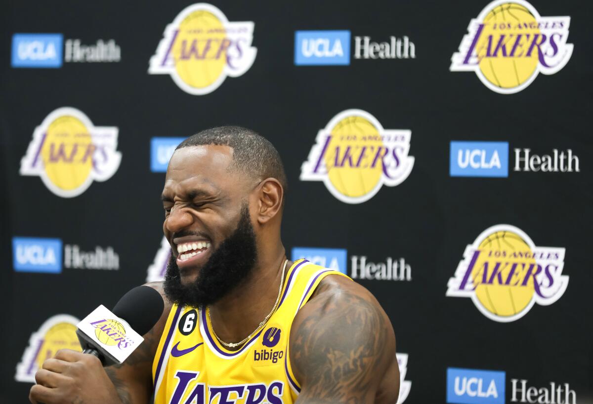 LeBron James laughs as he answers a question during media day.
