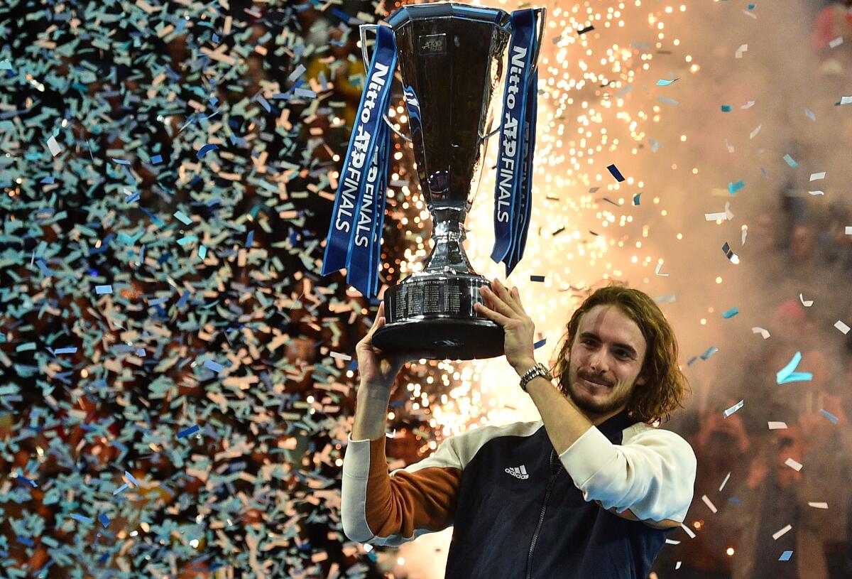 Stefanos Tsitsipas of Greece hoists the champion's trophy after winning the ATP Finals title on Nov. 17, 2019, in London.