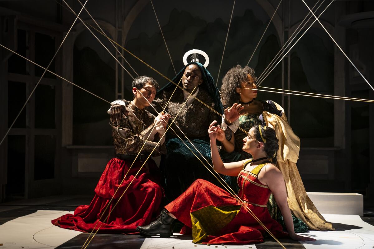 Four people onstage with wires pointing in various directions