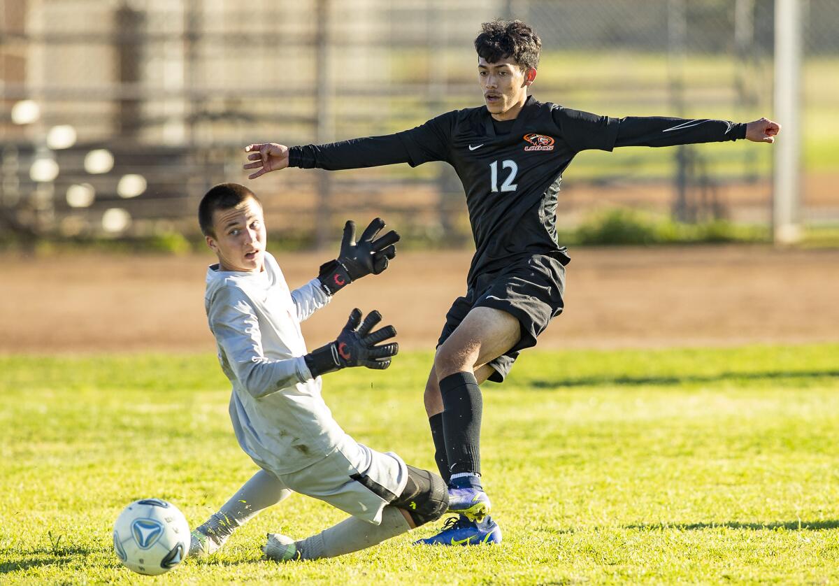 Los Amigos' Oracio Teriquez sends a ball past Esperanza goalkeeper John Moffett for a goal on Friday.