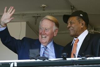 FILE - In this Oct. 2, 2016, file photo, Los Angeles Dodgers announcer Vin Scully waves to fans alongside Hall of Famer baseball player Willie Mays during the fourth inning of a baseball game between the San Francisco Giants and the Los Angeles Dodgers in San Francisco. On Monday, April 3, 2017, the Dodgers will play their first opening day since 1950 without Scully calling their games. He won’t be in the stands. He won’t make a point of watching on TV, either. (AP Photo/Tony Avelar, File)