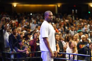 Kanye West appears on stage in front of a congregation at New Birth Missionary Baptist Church in Atlanta in 2019.