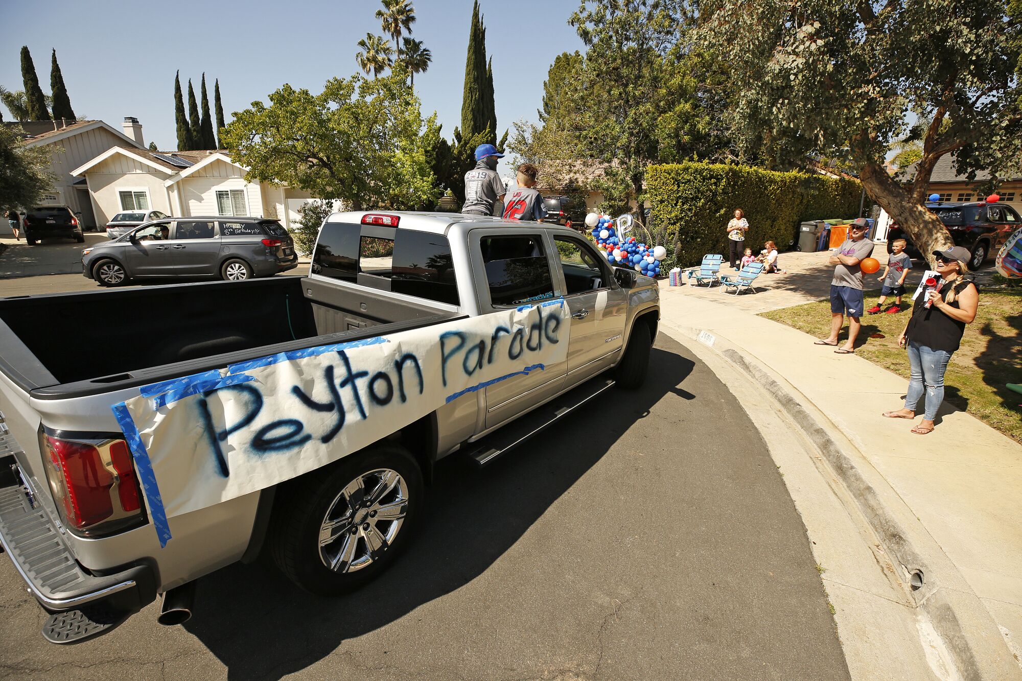 More than 25 vehicles filled with cheering parents and children drove through the cul de sac in front of the Buss home several times bestowing Peyton with balloons, gifts, cards and placards.