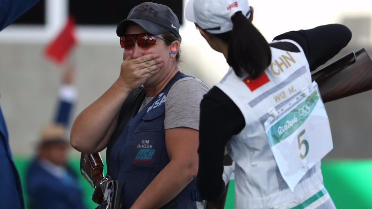 Kim Rhode tries to hold in her excitement after defeating Wei Meng of China, right, in a shootout for the bronze medal.