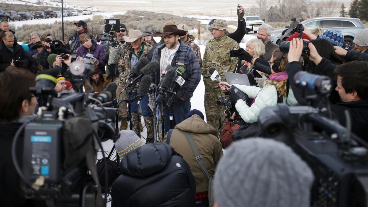 Ammon Bundy, center, one of the sons of Nevada rancher Cliven Bundy, speaks during a news conference at Malheur National Wildlife Refuge headquarters on Jan. 4, near Burns, Ore.