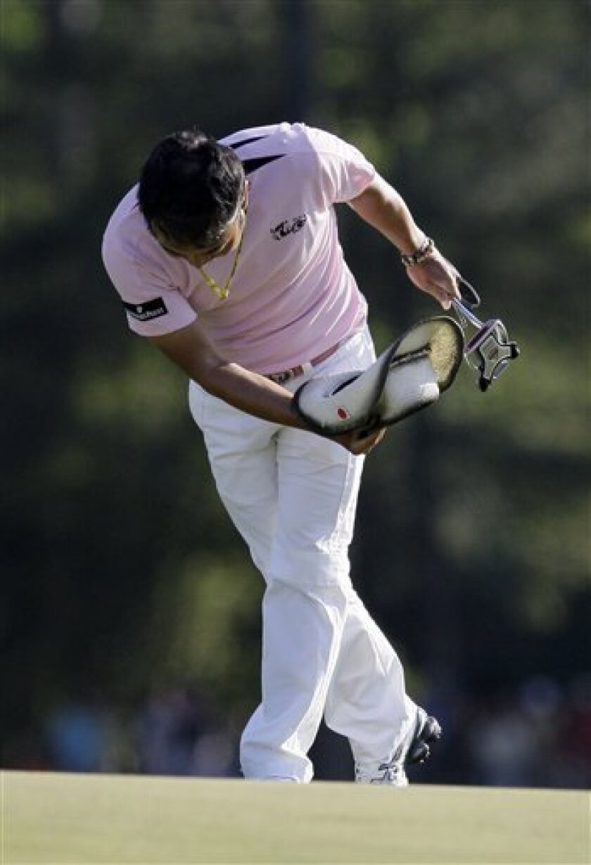 Shingo Katayama of Japan bows to the gallery as he walks up the 18th fairway during the final round of the Masters golf tournament at the Augusta National Golf Club in Augusta, Ga., Sunday, April 12, 2009. (AP Photo/David J. Phillip)