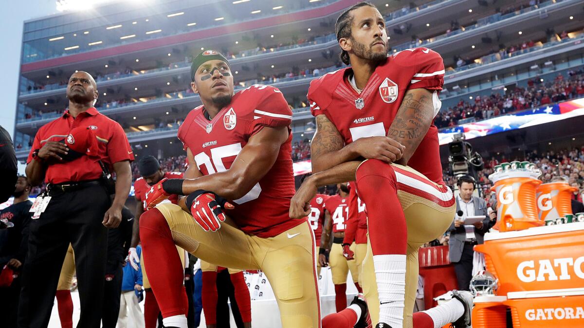 San Francisco 49ers safety Eric Reid (35) and quarterback Colin Kaepernick (7) kneel during the national anthem on Sept. 12 in Santa Clara, Calif.