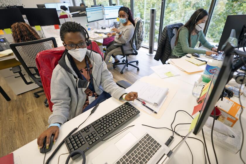 Contact tracers, from left to right, Christella Uwera, Dishell Freeman and Alejandra Camarillo work at Harris County Public Health contact tracing facility Thursday, June 25, 2020, in Houston. Texas Gov. Greg Abbott said Wednesday that the state is facing a "massive outbreak" in the coronavirus pandemic and that some new local restrictions may be needed to protect hospital space for new patients. (AP Photo/David J. Phillip)