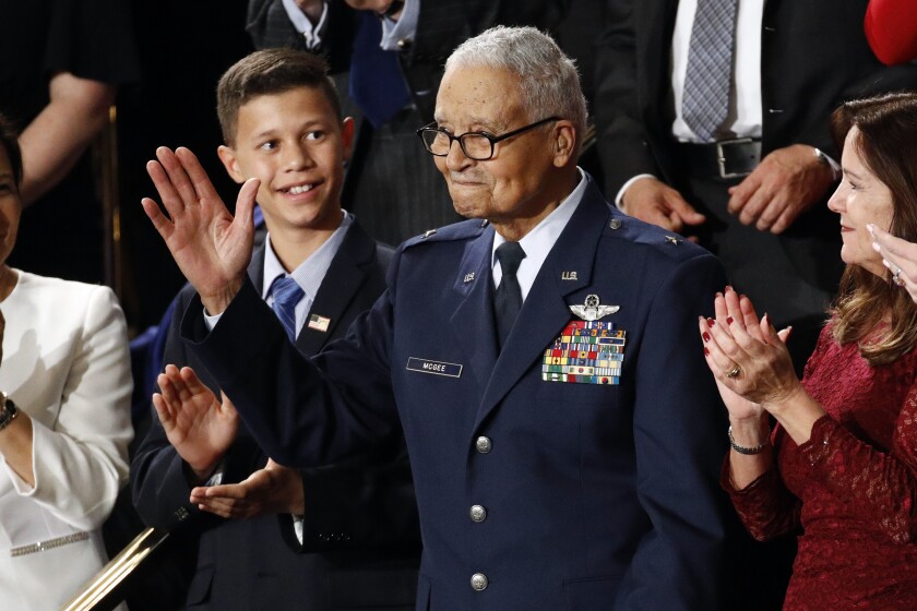 Tuskegee airman Charles McGee, 100, and his great grandson Iain Lanphier react as President Donald Trump delivers his State of the Union address to a joint session of Congress on Capitol Hill in Washington, Tuesday, Feb. 4, 2020. (AP Photo/Patrick Semansky)