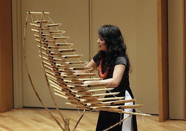 Van-Ahn Vanessa Vo plays the bamboo xylophone in "Cracking Bamboo" by Vu Nhat Tan.