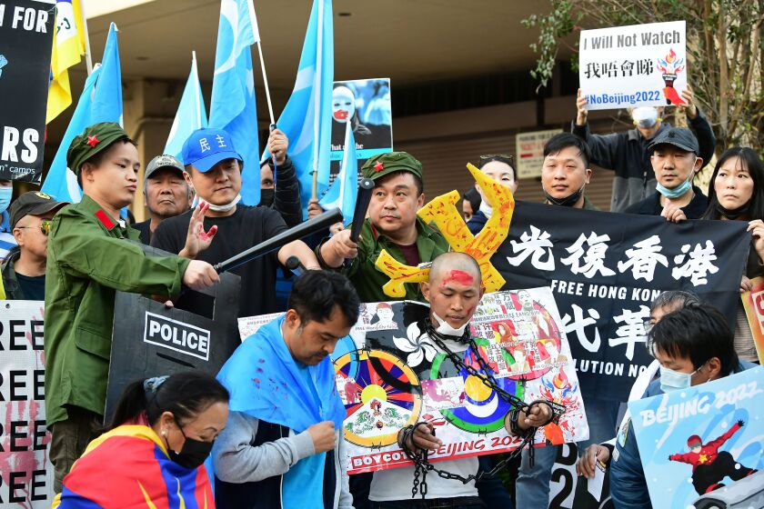 Activists call for a boycott of the 2022 Beijing Winter Olympics outside the Chinese Consulate in Los Angeles on Feb. 3.