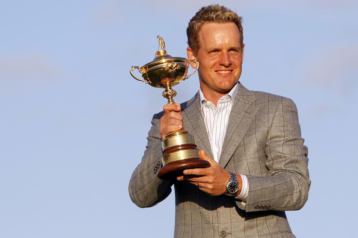 FILE - Europe's Luke Donald holds the Ryder Cup after Europe defeated the United States on the final day of the 2010 Ryder Cup golf matches at the Celtic Manor Resort in Newport, Wales, on Oct. 4, 2010. Donald has been selected Ryder Cup captain for Europe, taking over for Henrik Stenson after the Swede was stripped of the job for signing on with the Saudi-funded LIV Golf series. (AP Photo/Alastair Grant, File)