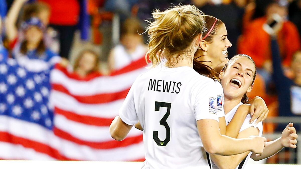 U.S. forward Alex Morgan, center, celebrates a goal with teammates Samantha Mewis and Kelley O'Hara in the second half of a 5-0 win over Trinidad and Tobago.