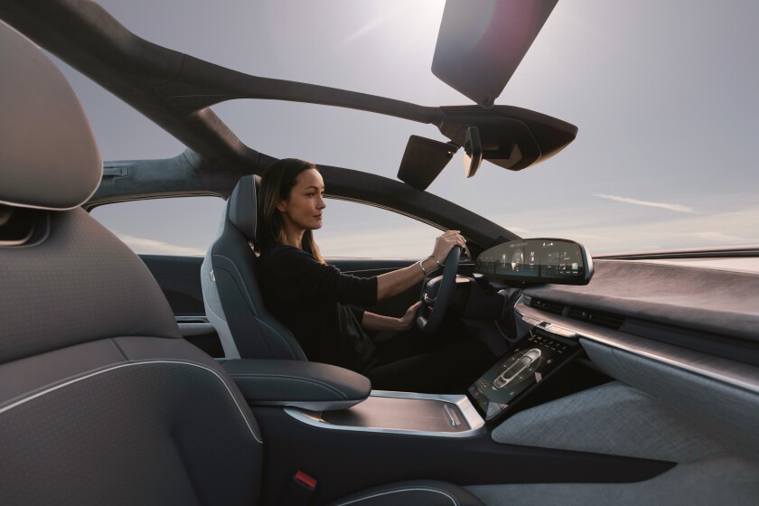 A woman uses touchscreen inside Lucid Air
