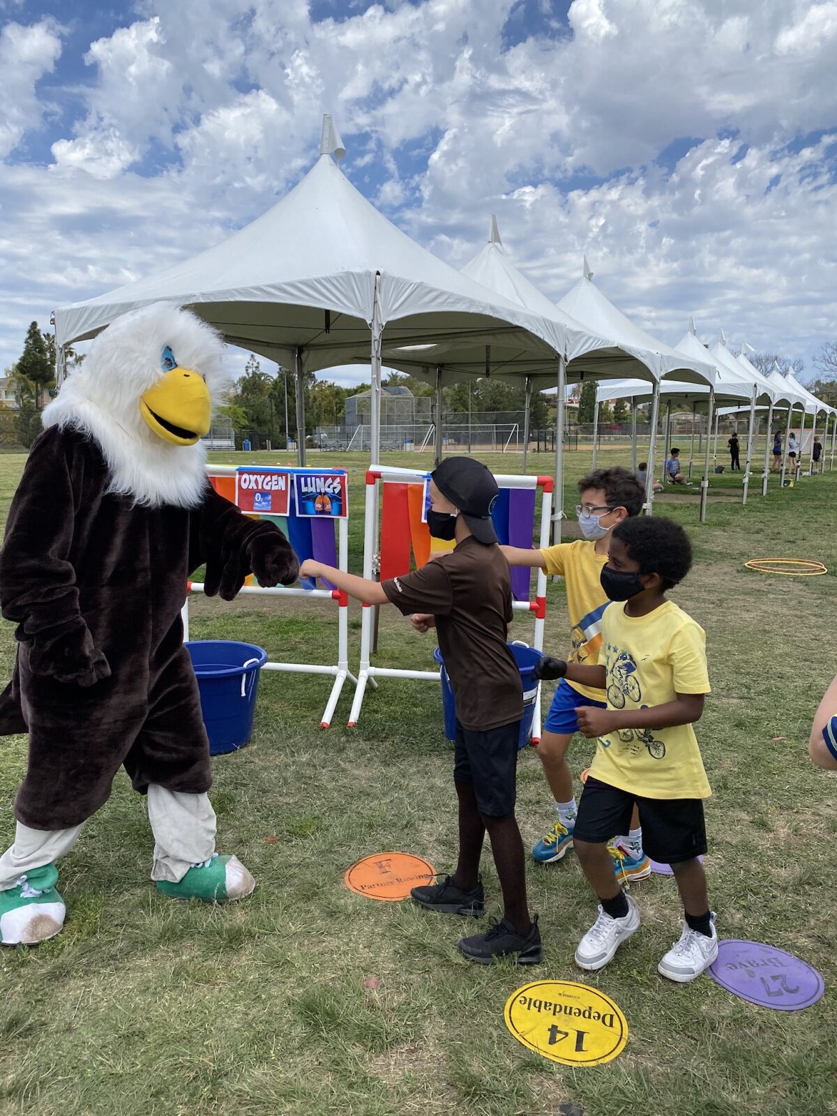 Students at Ashley Falls get fist bumps from the Eagle mascot.