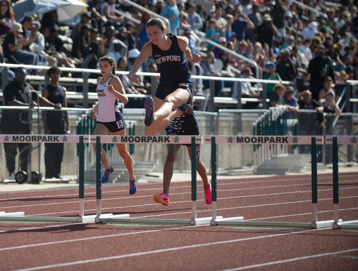 Newport Harbor's Natalie McCarty leaps into the home stretch of the 300-meter hurdles in the CIF  track and field finals.