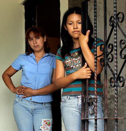 Security guard Fernando Rodriguez, who was killed in the attack at Lozano Garza jewelry store, took the $90-a-month job to save for the 15th birthday celebration of his daugher, Esmeralda, left. She and her sister Areli, right, live with their widowed mother and a younger sister in a barrio outside Monterrey.