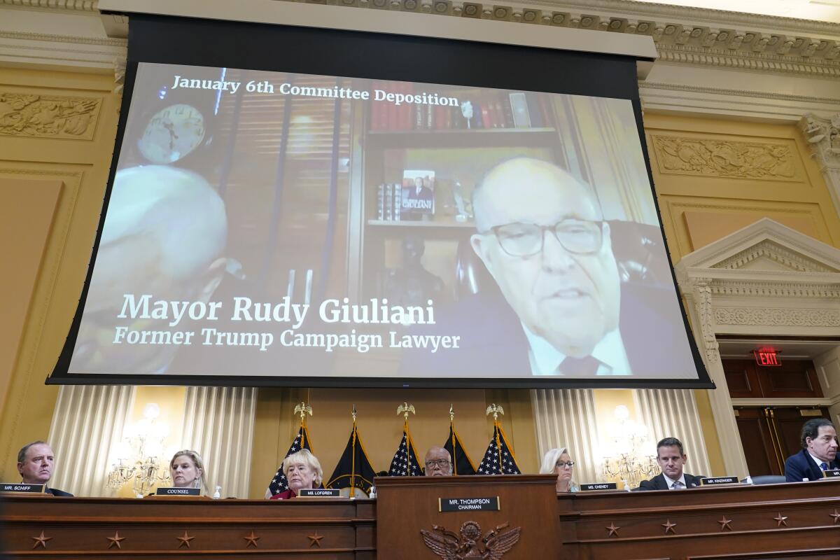 FILE - A video deposition of former Trump campaign attorney and former New York Mayor Rudolph Giuliani plays as the House select committee investigating the Jan. 6 attack on the U.S. Capitol continues to reveal its findings of a year-long investigation, at the Capitol in Washington, Monday, June 13, 2022. (AP Photo/Susan Walsh, File)