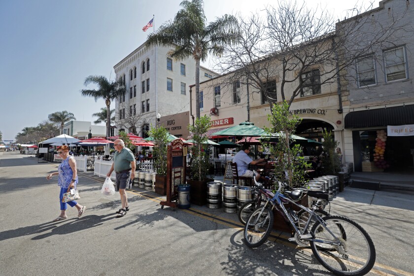 A lunchtime crowd visits downtown Ventura on Oct. 7.