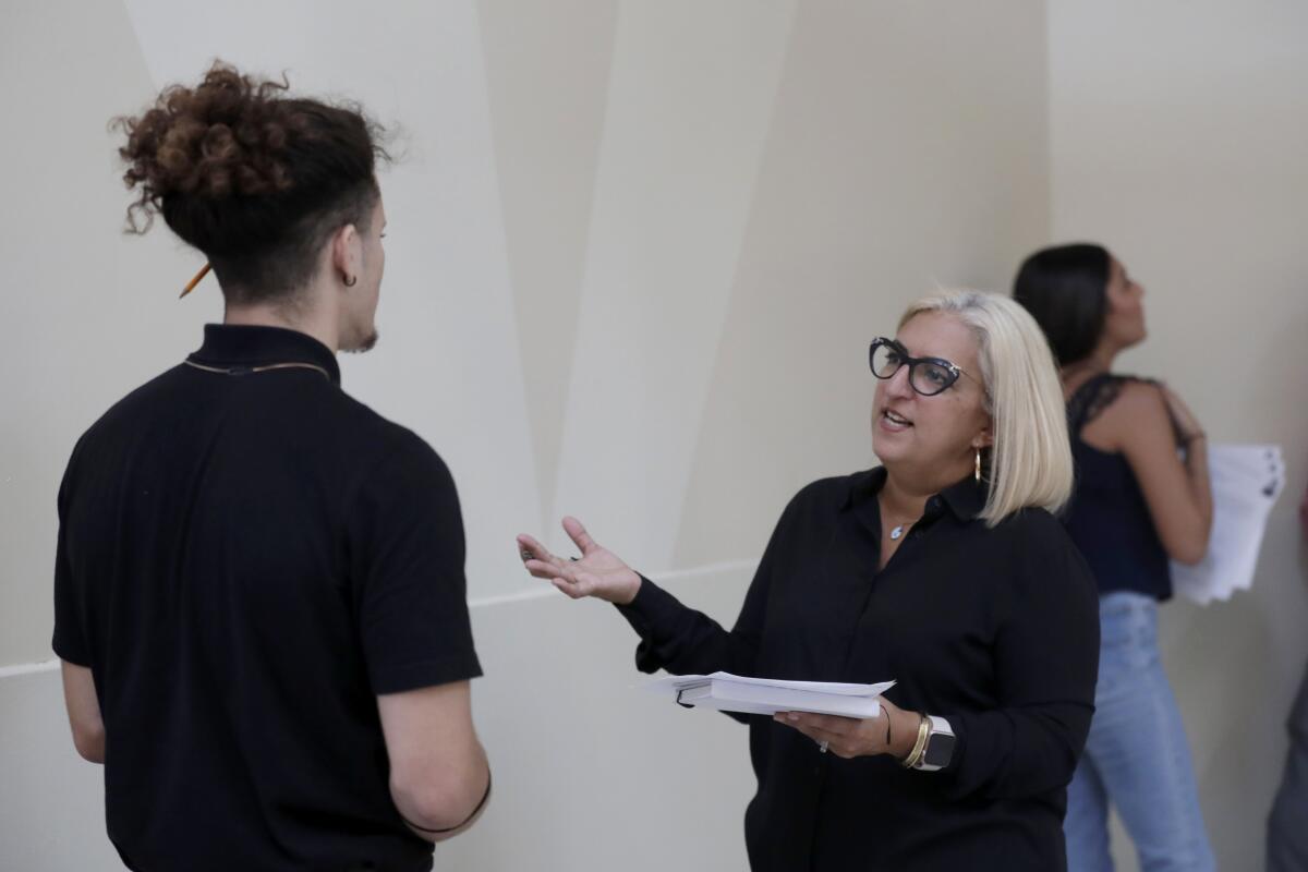 Gory Rodriguez of Starbucks, right, interviews a job applicant during a job fair in Miami on Oct. 1, 2019.
