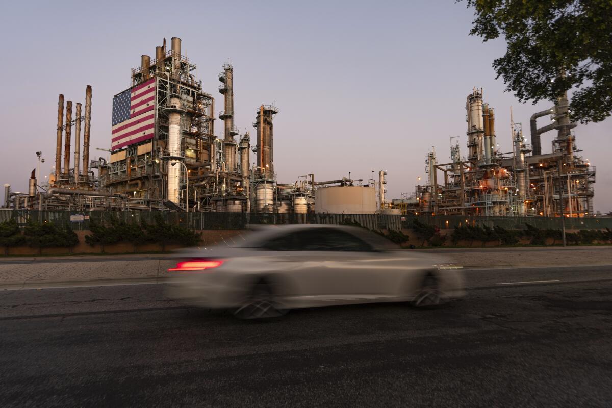 A car drives past Marathon Oil's Los Angeles Refinery complex in Cars