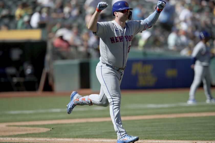 New York Mets designated hitter Pete Alonso (20) reacts after a home run in the fourth inning of a baseball game against the Oakland Athletics in Oakland, Calif., on Sunday, Sept. 25, 2022. (AP Photo/Scot Tucker)