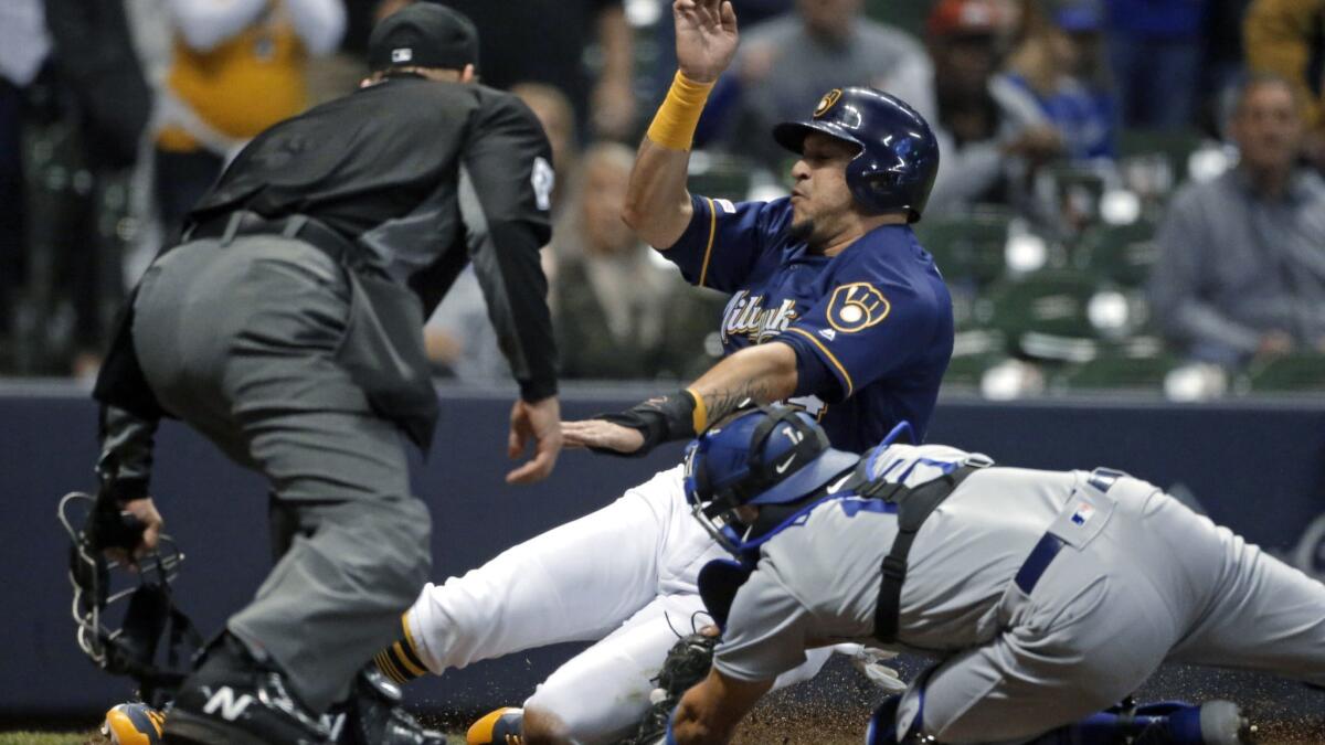 Milwaukee Brewers' Hernan Perez is tagged out at home by Dodgers' Austin Barnes during the eighth inning.