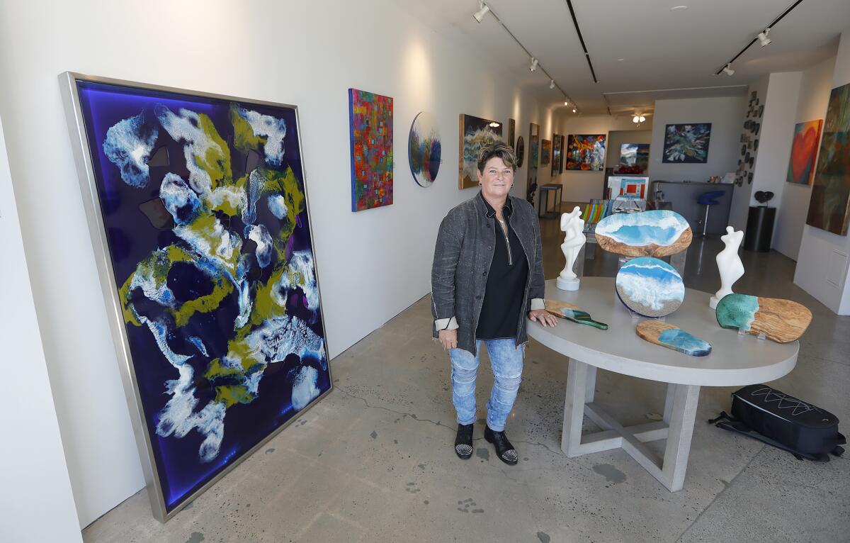 Artist Christie Smith moved from Half Moon Bay in Northern California to open an art gallery in downtown Laguna Beach. 