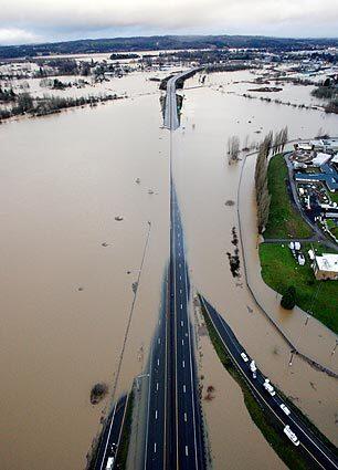 Floodwaters from the Chehalis River cover Interstate 5 in Chehalis, Wash., about 80 miles southwest of Seattle. Rain and high winds lashed Washington state Wednesday, causing widespread avalanches, rapid snowmelt, mudslides, flooding and road closures.