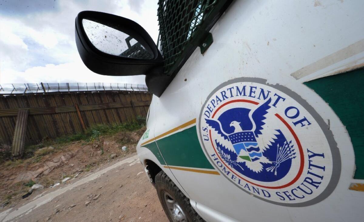 A U.S. Border Patrol vehicle keeps watch beside the fence that divides the U.S. from Mexico in Nogales, Arizona. The U.S. Supreme Court will decided whether its 2010 decision on immigrants' right to counsel should apply retroactively.