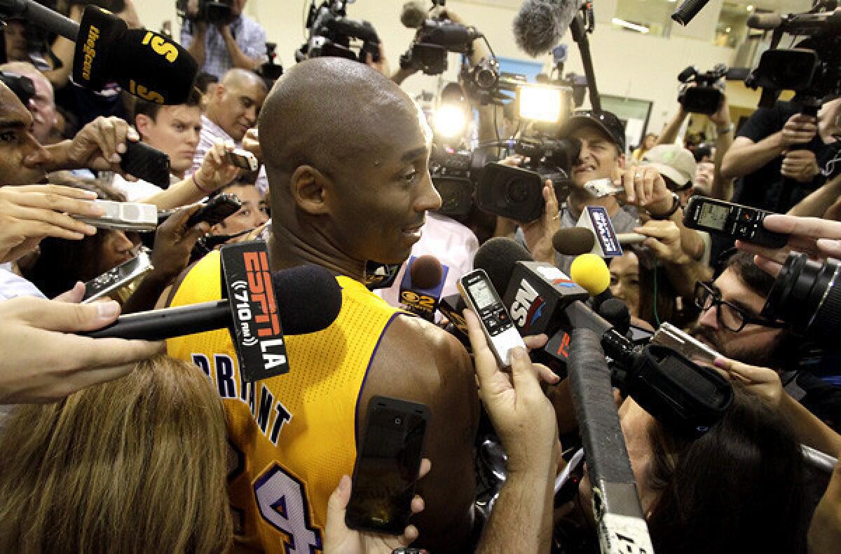 Kobe Bryant is swarmed by reporters during media day.
