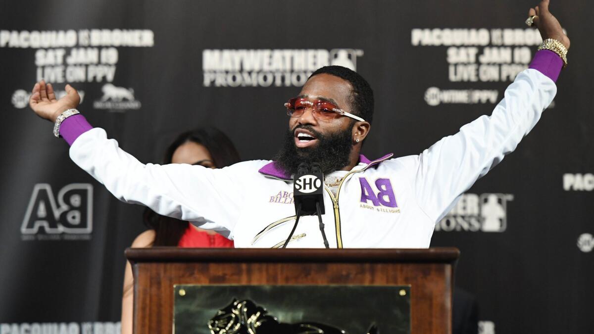 Adrien Broner stretches as he takes the podium to speak at a news conference at MGM Grand Hotel & Casino on Wednesday in Las Vegas. Broner will challenge Manny Pacquiao for his title on Saturday.