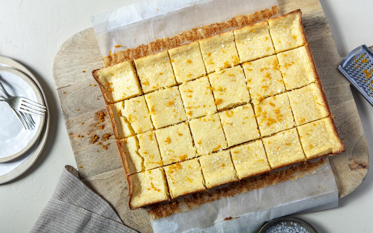 Gooey Butter Cake Squares garnished with orange zest, cut into 24 bars